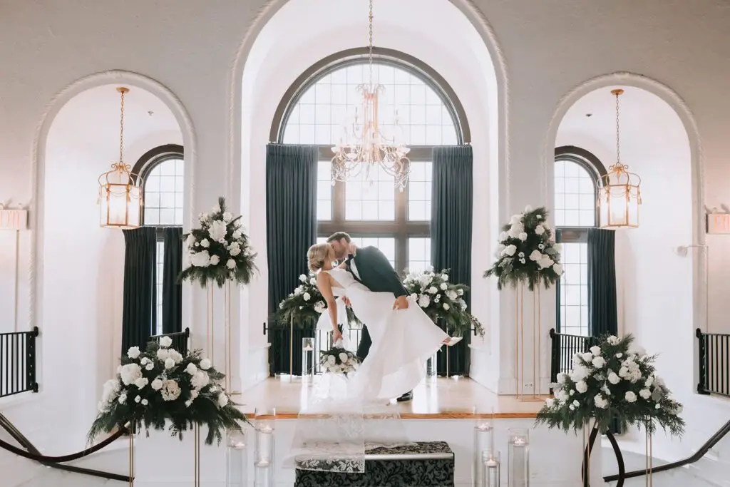 A couple kissing after being married at Pine Ridge Country Club